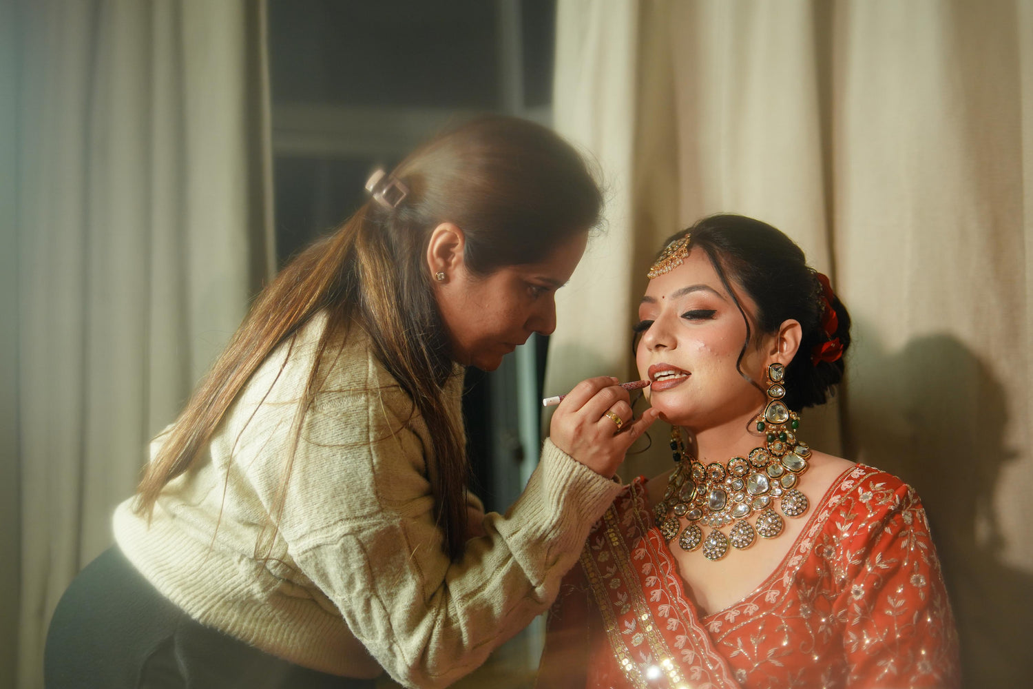 Sugandha KM , expert bridal makeup artist, ceo of The Bridal Room adding final touches on the makeup of her client.