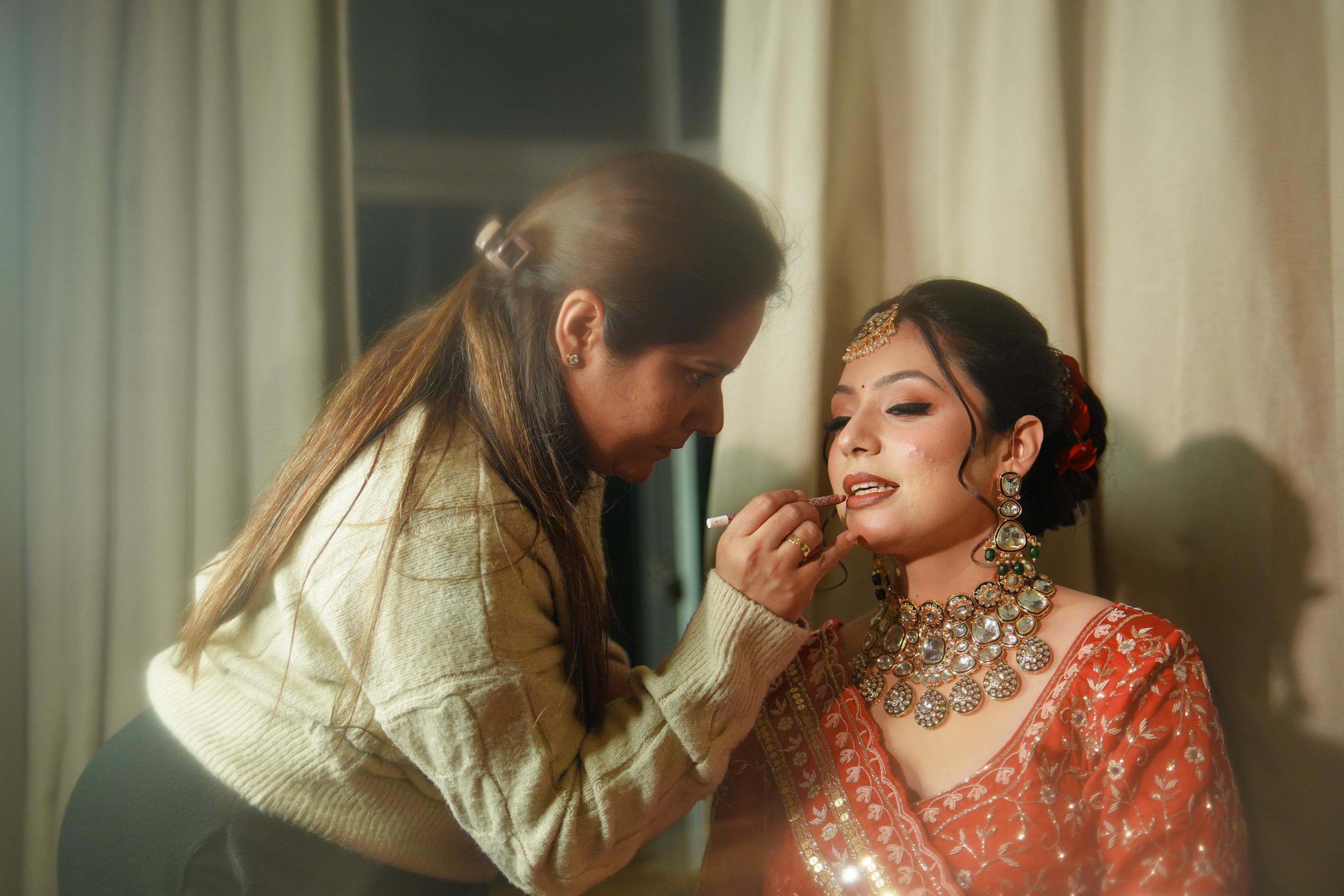 Sugandha KM , expert bridal makeup artist, ceo of The Bridal Room adding final touches on the makeup of her client.